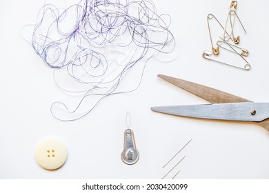 Tangled Threads, Needles, Threading, Safety Pins And Scissors Mockup Against White Background