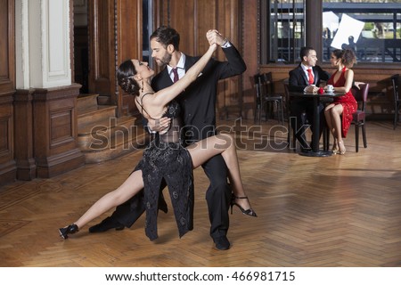 Tango Dancers Performing While Couple Dating In Restaurant