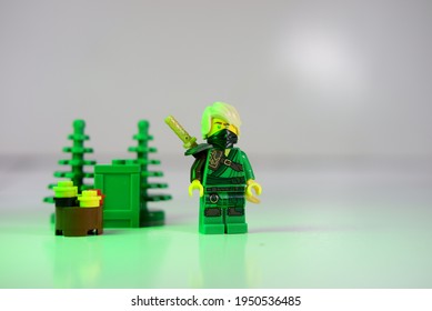 Tangsel, Indonesia - March 30, 2021: Lloyd The Green Ninja Highlighted With Green Light. Lego Minifigs Are Made By The Lego Group