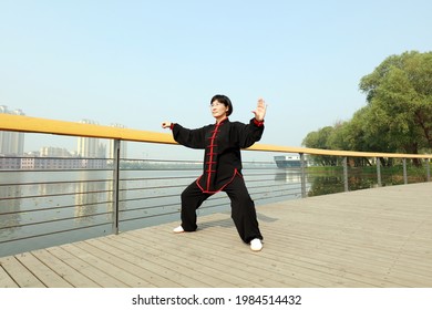 Tangshan City, Hebei Province, China - May 11, 2019:A Woman In Black Is Practicing Taijiquan In The Park.