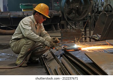 TANGSHAN - JUNE 20: Workers cutting the steel plate in a steel plant, on June 20, 2014, Tangshan city, Hebei Province, China 
