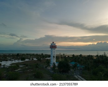 Tanjungpinang, Bintan Island, Indonesia, March 04, 2022: Aerial view of the lighthouse standing on the beach of Terkulai Island at sunset, Bintan, Indonesia