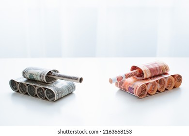 Tank Of Dollar And Ruble Banknotes On A White Table Background. Bills. The Concept Of Arms Supply, Purchase And Sale Of Firearms, America Vs. Russia, Crumpled Money