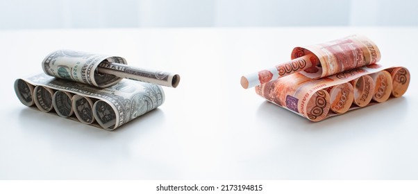 Tank Of Dollar And Ruble Banknotes On A White Table Background. Bills. The Concept Of Arms Supply, Purchase And Sale Of Firearms, America Vs. Russia, Crumpled Money