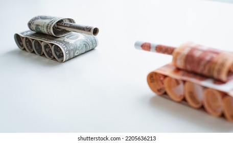 Tank Of Dollar And Ruble Banknotes On A White Table Background. Bills. The Concept Of Arms Supply, Purchase And Sale Of Firearms, America Vs. Russia, Crumpled Money