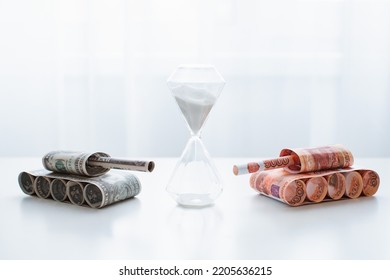 Tank Of Dollar And Ruble Banknotes On A White Table Background. Bills. The Concept Of Arms Supply, Purchase And Sale Of Firearms, America Vs. Russia, Crumpled Money