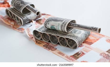 Tank Made Of Dollar Bills Rides On A Road Made Of Ruble Banknotes Bills. The Concept Of Arms Supply, Purchase And Sale Of Firearms, America Vs. Russia, Crumpled Money