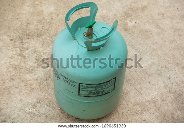 A tank of Refrigerant isolated,Old Gas bottle on\
the floor.