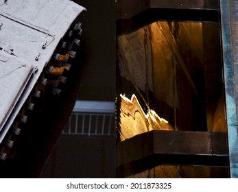 Tank Tread And Gold Light Reflected In A Black Side Panel