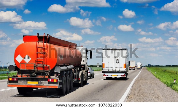 The\
tank truck is moving along the highway. Back\
view