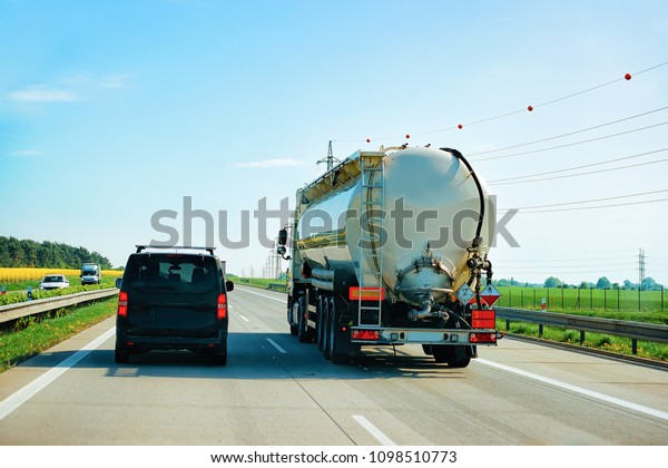 Tanker storage truck and car on the highway in\
Czech republic