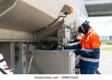 A Tanker Truck Driver Delivers Gasoline To A Gas Station