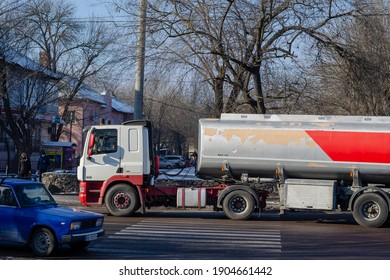 A Tanker Truck Moving In City Traffic. Grey And Red Liquid Cargo Truck: Mykolaiv, Ukraine - January 21, 2021