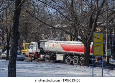 A Tanker Truck Moving In City Traffic. Grey And Red Liquid Cargo Truck: Mykolaiv, Ukraine - January 21, 2021