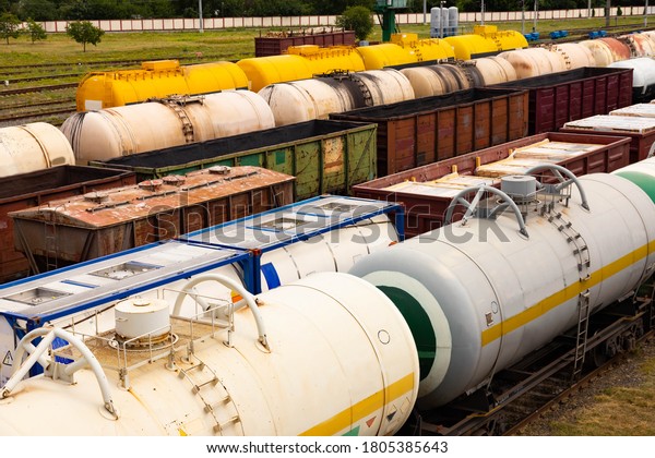 Tanks with fuel,\
wagons with cargo at a freight railway station. Logistics and\
transportation concept.
