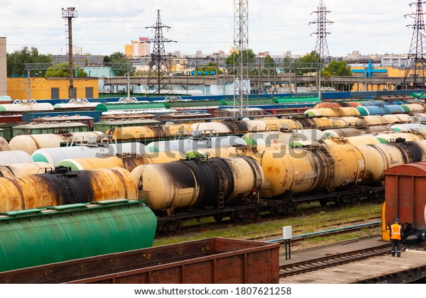 Tanks with fuel,\
wagons with cargo at a freight railway station. Logistics and\
transportation concept.