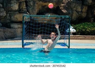 Tanned Caucasian Kids Playing Water Polo On A Sunny Summer Day.