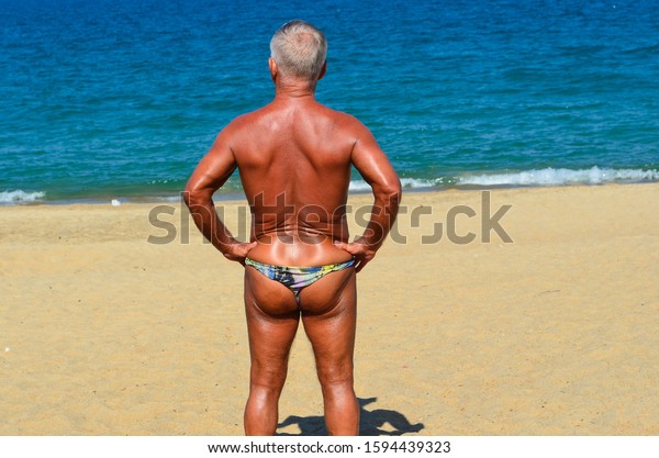 tanned-man-on-seashore-shorts-600w-1594439323.jpg