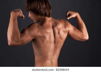 Tanned muscular young man, power bodybuilding - Shutterstock ID 82508419