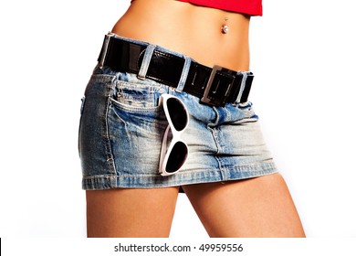 Tanned Woman Body In Short Jeans Skirt With Sunglasses In Pocket, Studio White