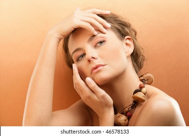 Tanned Woman Touching Face