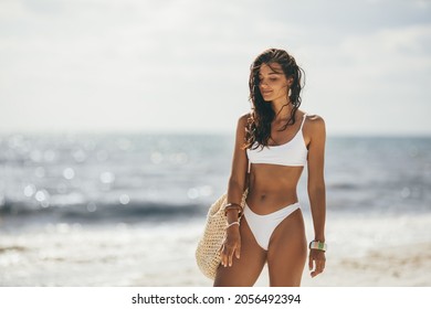 Tanned Woman in White Bikini on the Summer Beach
