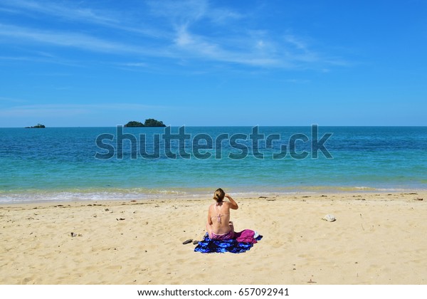 Tanning at the beach,\
Koh Chang, Thailand