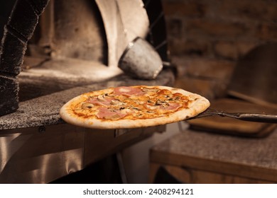 A tantalizing pizza with golden cheese and toppings, served on a peel right out of the wood-fired oven's warm embrace - Powered by Shutterstock