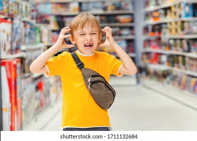 ?hildren's tantrum in the store. Boy can't selecting toy in kids store. Many toys around. Shop toys.Inside toy shop. Little boy getting hysterical in toy shop.Kid makes difficult choice in supermarke