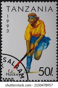TANZANIA - CIRCA 1993: a postage stamp from TANZANIA, showing a woman playing field hockey with a hockey stick at play. Circa 1993