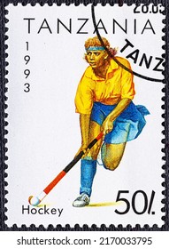 TANZANIA - CIRCA 1993: a postage stamp from TANZANIA, showing a woman playing field hockey with a hockey stick at play.