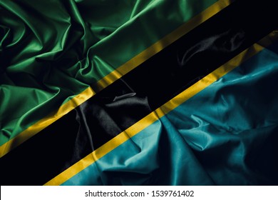 Tanzania Flag Consists Of A Yellow-edged Black Diagonal Band Divided Diagonally From Green And Blue Triangles. The Colors Represents The Natural Vegetation, Swahili People And The Indian Ocean.
