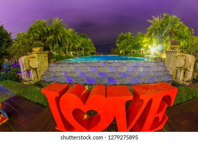 Tanzania , Zanzibar - January 2, 2019. Celebration of St. Valentine's Day on the tropical islands. luxury vacation. Inscription love and night lights on the background of exotic palms and night sky