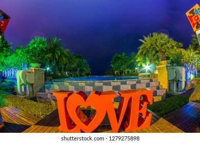 Tanzania , Zanzibar - January 2, 2019. Celebration of St. Valentine's Day on the tropical islands. luxury vacation. Inscription love and night lights on the background of exotic palms and night sky