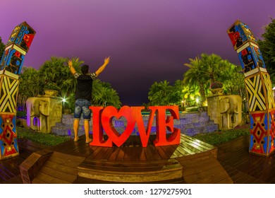 Tanzania , Zanzibar - January 2, 2019. Celebration of St. Valentine's Day on the tropical islands. luxury vacation. Inscription love and night lights on the background of exotic palms and night sky