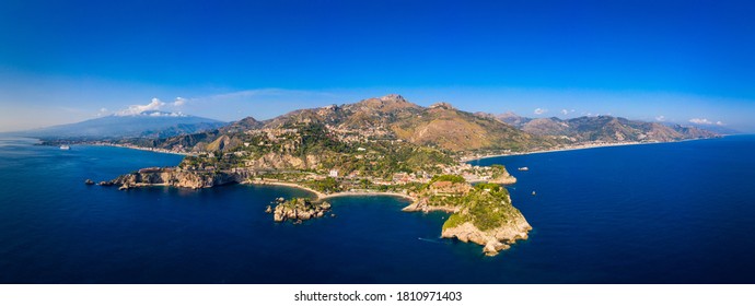 Taormina is a city on the island of Sicily, Italy. Mount Etna over Taormina cityscape, Messina, Sicily. View of Taormina located in Metropolitan City of Messina, on east coast of Sicily island, Italy.