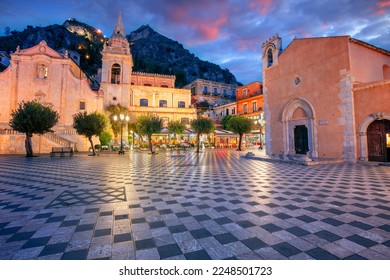 Taormina, Sicily, Italy. Cityscape image of picturesque town of Taormina, Sicily with main square Piazza IX Aprile and San Giuseppe church at sunset.