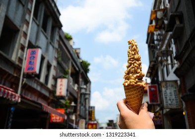 Taoyuan, Taiwan - AUG 01, 2018:Hand Holding Ice Cream In Daxi Old Street.