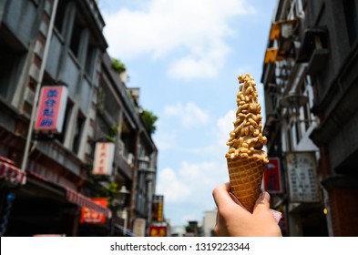 Taoyuan, Taiwan - AUG 01, 2018:Hand Holding Ice Cream In Daxi Old Street.