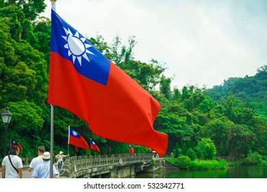 Taoyuan, Taiwan - May 2016: The tourists walking a road and the national flag of ROC in Chiang Kai-shek's tomb, Cihu, Taoyuan city