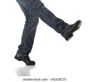 Tap Dancer In Blue Jeans And Tap Shoes Doing Steps On A White Background And Floor