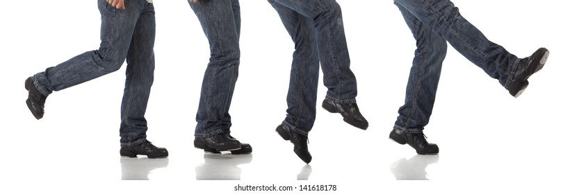 Tap Dancer In Blue Jeans And Tap Shoes Doing Steps On A White Background And Floor