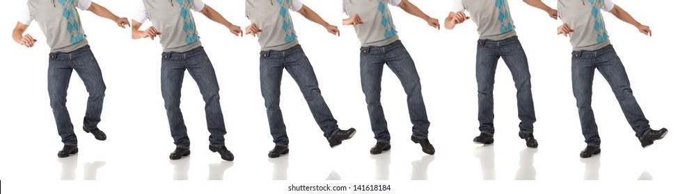 Tap Dancer In Blue Jeans And Tap Shoes Doing Steps On A White Background And Floor