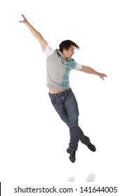 Tap Dancer In Blue Jeans And Tap Shoes Doing Steps On A White Background And Floor