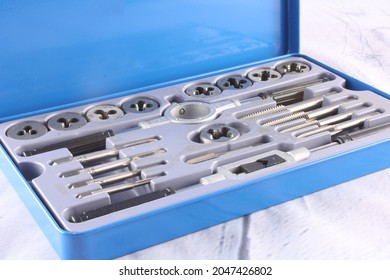 Tap And Die Set For Threading, Repairing And Rethreading ISO Metric Screws. Isolated On Pale Backgroun  With Copy Space