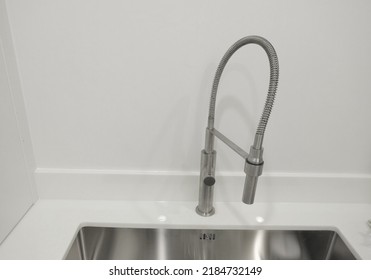 Tap Faucet Stainless Steel On White Stone Worktop And Undermount Sink