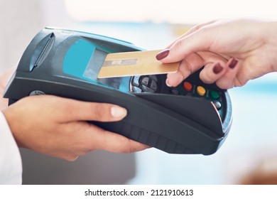 Tap And Go. Cropped Shot Of A Customer Using Her Credit Card To Make A Payment.