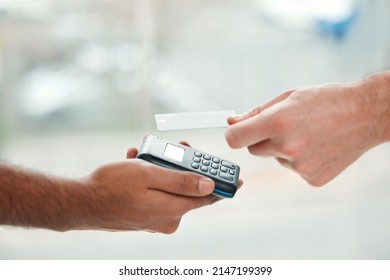 Tap To Pay. Closeup Shot Of An Unrecognizable Man Paying His Bills Via Wireless Card Reader.