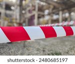 Tap red white color warning barrier safety hazard caution stop line sign in industrial factory area