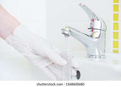 Tap Water Analysis Quality Control Concept. Hand With A Flask And Water Tap Ckose Up.